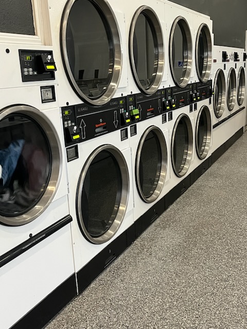 Two rows of laundry machines